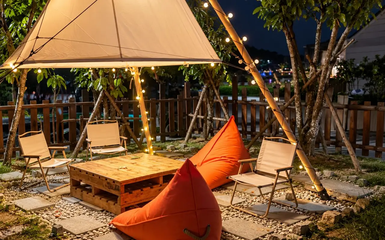 Garden lounge with bean bags and string lights in the evening