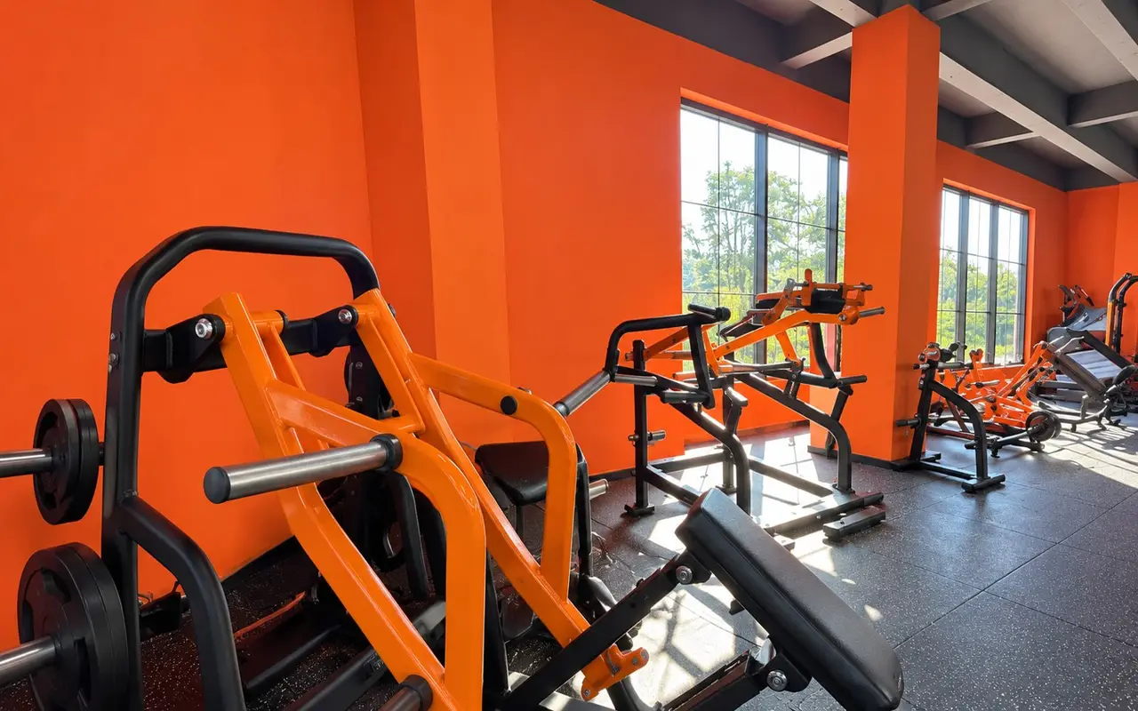 Strength gym with orange machines and racks
