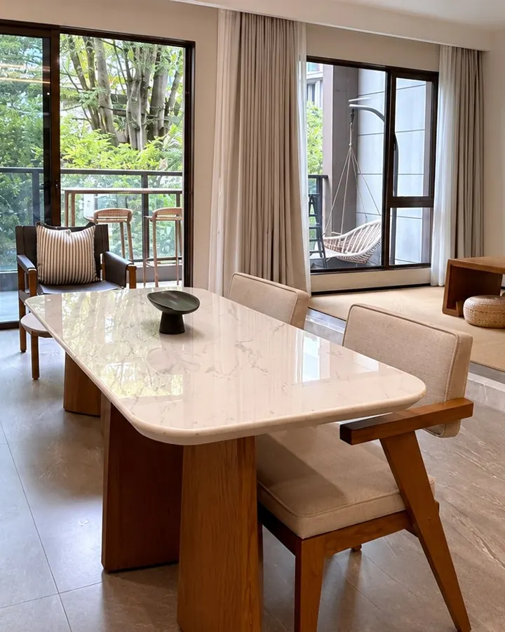 Bright shared living room with sofa, dining table and garden view