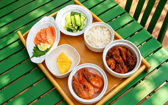 Salmon, prawns, chicken, cucumber, rice and pineapple